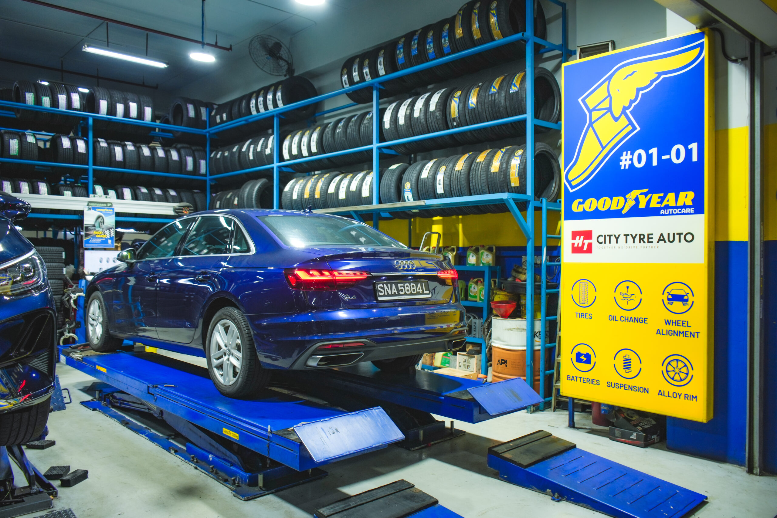 Tyre replacement Sin Ming service bay with car on hydraulic lift at City Tyre Auto Sin Ming Goodyear Autocare workshop