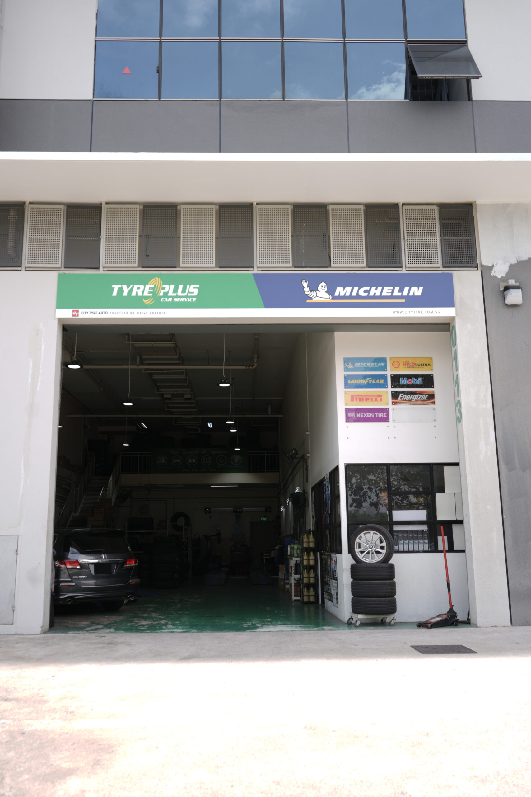 TYREPLUS Woodlands tyre shop and car workshop exterior at 71 Woodlands Industrial Park E9 WAVE9 — minutes from Woodlands Checkpoint