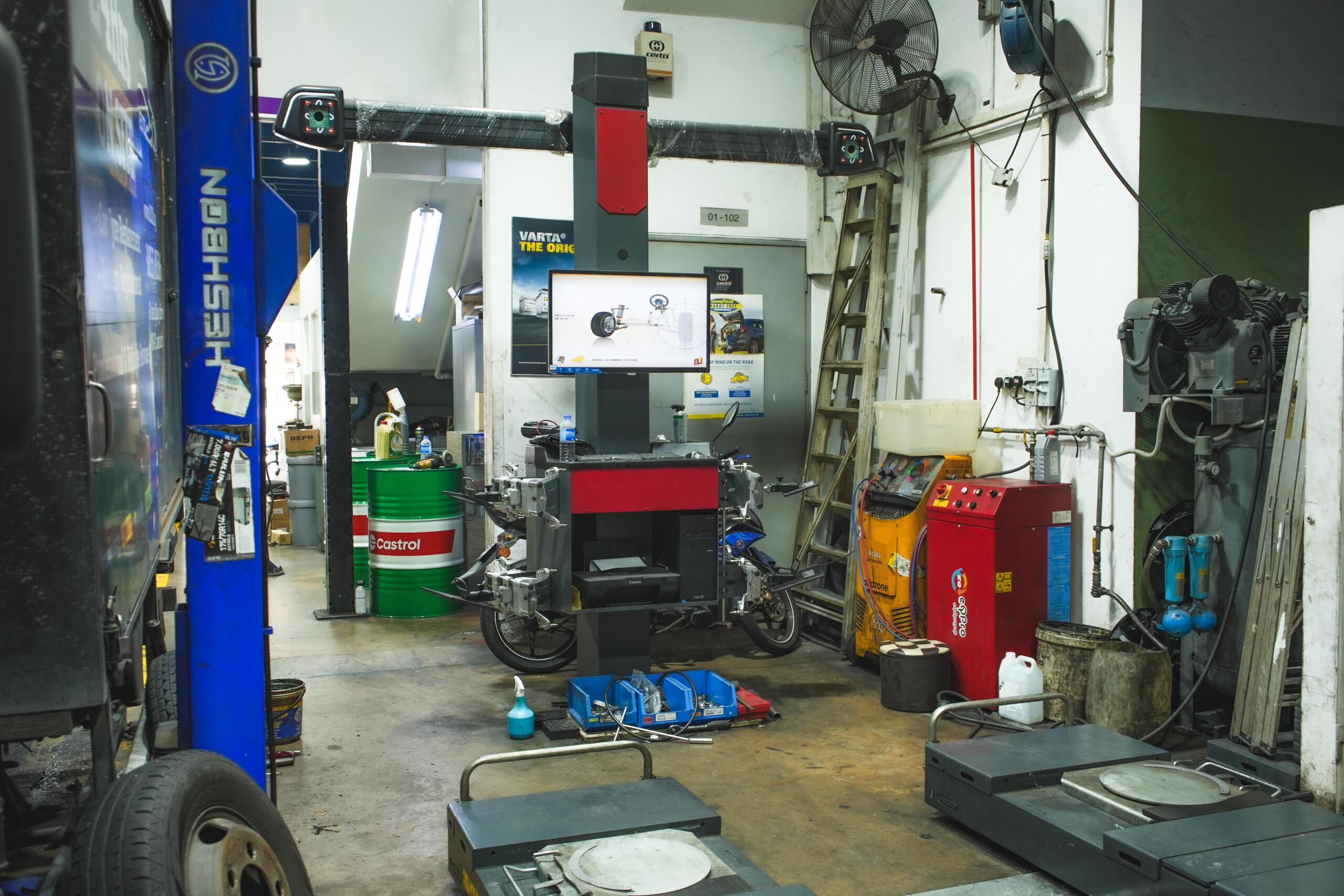 Precision wheel alignment in progress at TYREPLUS Toh Guan car workshop