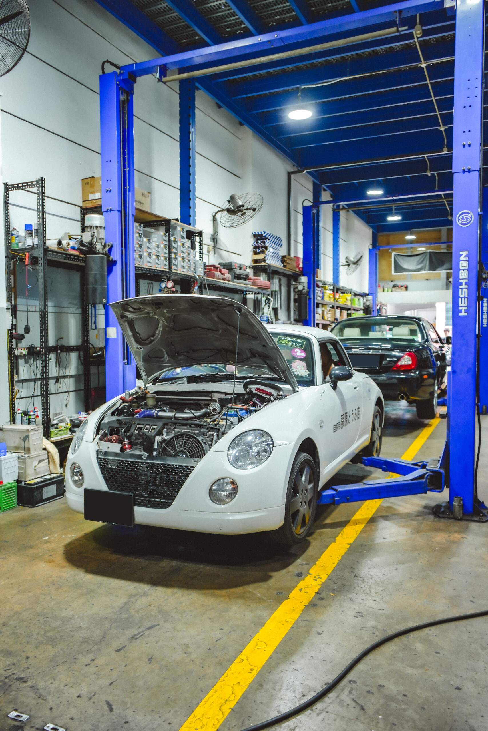 Tyre replacement Toh Guan service bay with car on hydraulic lift at TYREPLUS Toh Guan workshop